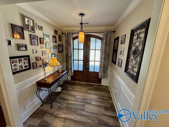 doorway to outside featuring crown molding and french doors