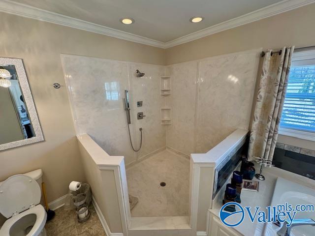 bathroom with crown molding and tiled shower