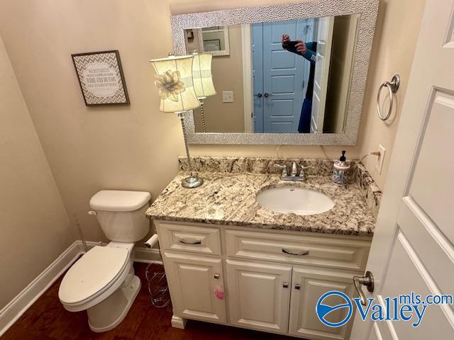 bathroom featuring vanity and toilet