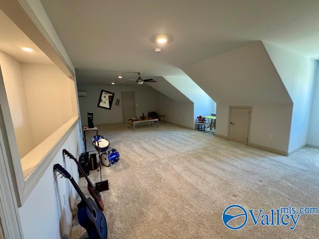 bonus room featuring lofted ceiling, light colored carpet, and ceiling fan