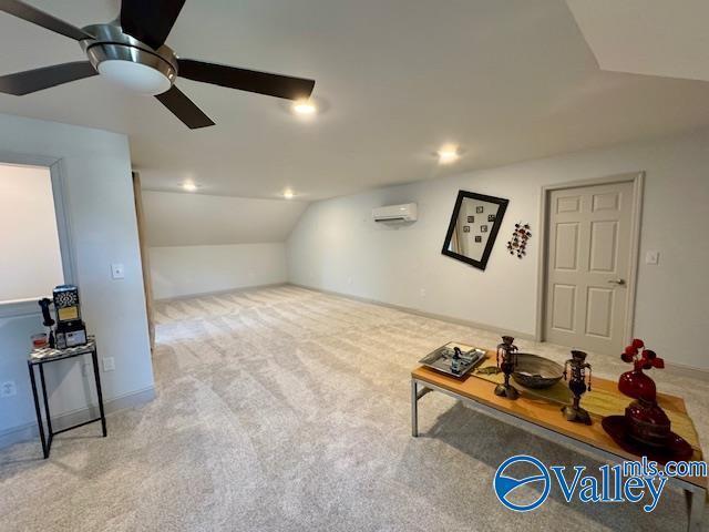 interior space with ceiling fan, vaulted ceiling, light carpet, and an AC wall unit