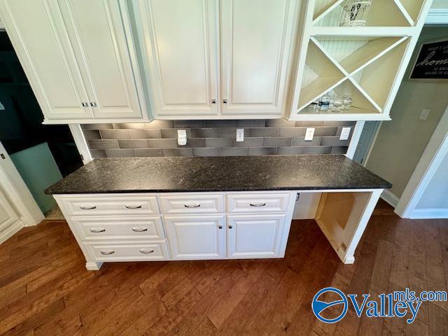 kitchen featuring white cabinetry, backsplash, and dark hardwood / wood-style flooring