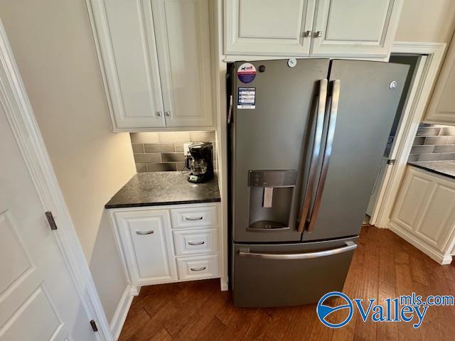 kitchen featuring dark wood-type flooring, white cabinets, backsplash, and stainless steel fridge with ice dispenser