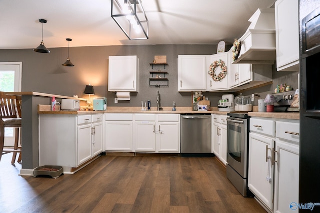 kitchen featuring appliances with stainless steel finishes, a sink, a peninsula, dark wood-type flooring, and custom exhaust hood