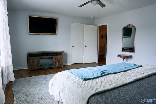 bedroom featuring baseboards, ceiling fan, and wood finished floors