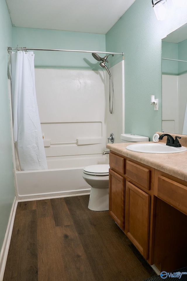 bathroom featuring vanity, shower / bath combo, toilet, and wood finished floors