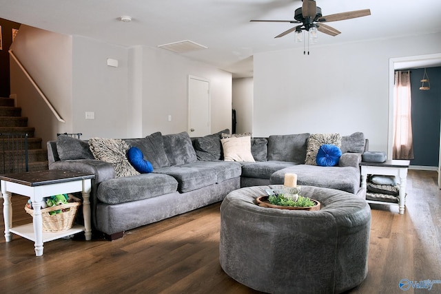 living room with a ceiling fan, stairs, and wood finished floors