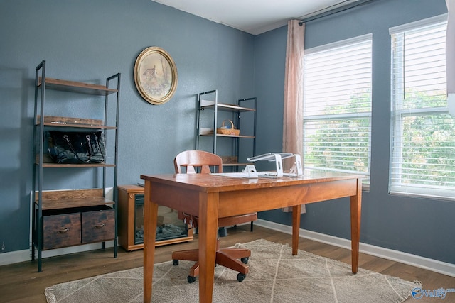home office featuring baseboards and wood finished floors
