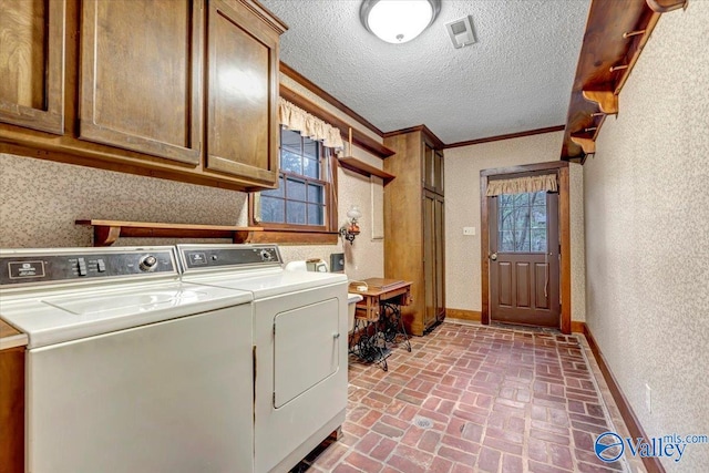 laundry room featuring ornamental molding, cabinets, separate washer and dryer, and plenty of natural light