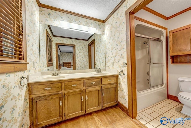 full bathroom featuring a textured ceiling, toilet, hardwood / wood-style flooring, and crown molding