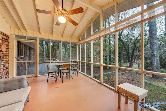 sunroom / solarium featuring vaulted ceiling with beams and ceiling fan