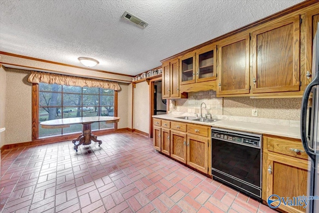 kitchen with decorative backsplash, sink, black dishwasher, and a textured ceiling