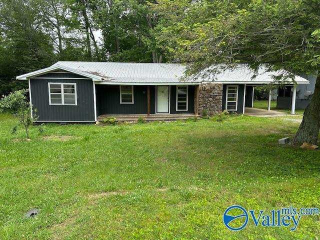 196 Johnson St, Rainsville, AL 35986 - view of front of property with a carport, a front yard, metal roof, and a porch