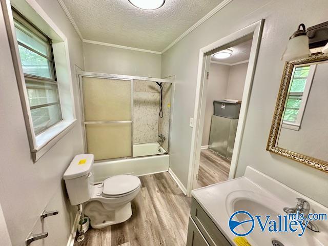 196 Johnson St, Rainsville, AL 35986 - bathroom with a textured ceiling, wood finished floors, toilet, shower / bath combination with glass door, and vanity