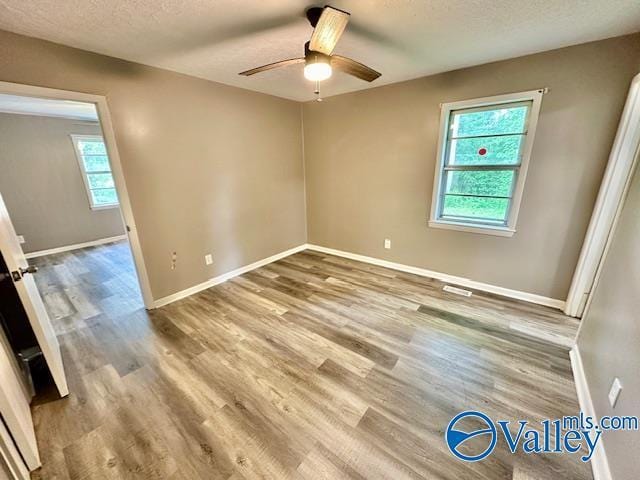196 Johnson St, Rainsville, AL 35986 - unfurnished room featuring a ceiling fan, baseboards, wood finished floors, and a textured ceiling