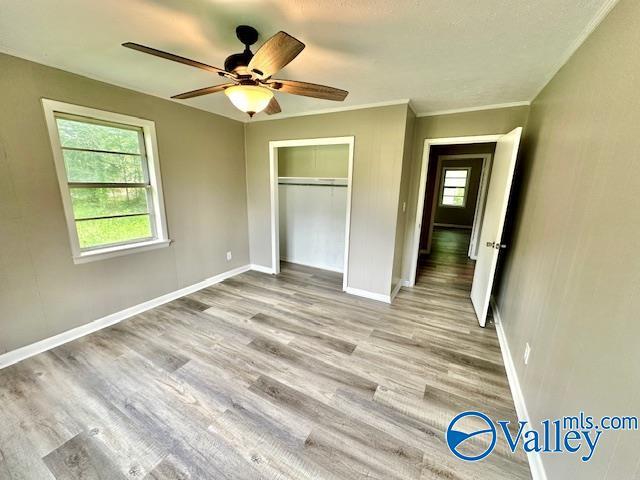 196 Johnson St, Rainsville, AL 35986 - unfurnished bedroom with wood finished floors, baseboards, and a closet