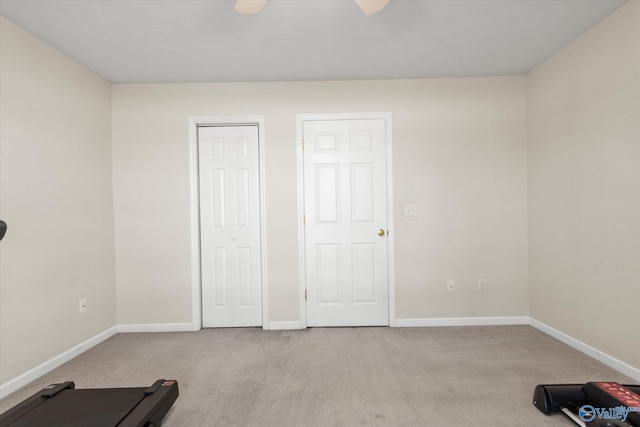 unfurnished bedroom with ceiling fan and light colored carpet