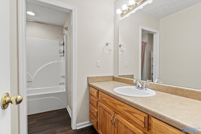 bathroom featuring shower / bathtub combination with curtain, a textured ceiling, vanity, and wood-type flooring