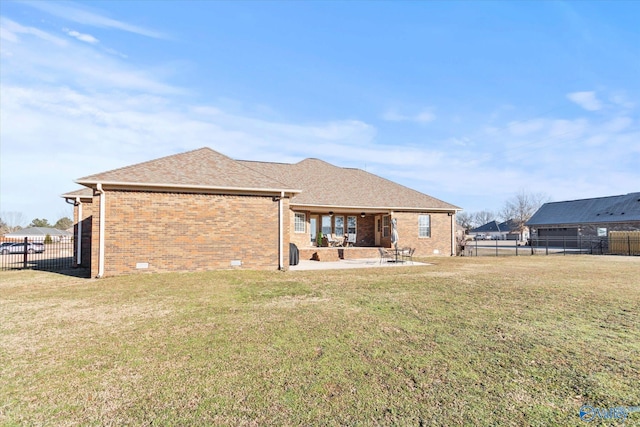 rear view of house with a lawn and a patio area