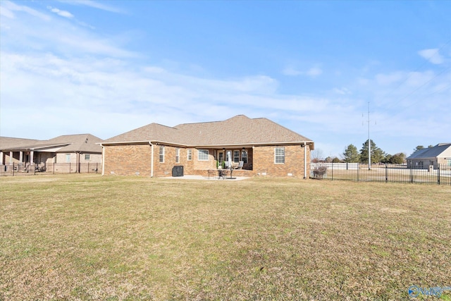 back of property with a patio and a lawn