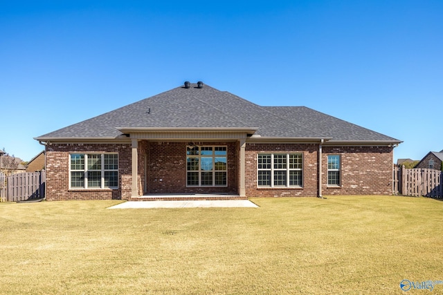 rear view of property with a patio area and a yard