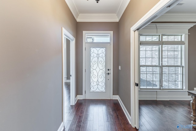 entrance foyer with dark wood-type flooring, ornamental molding, and plenty of natural light