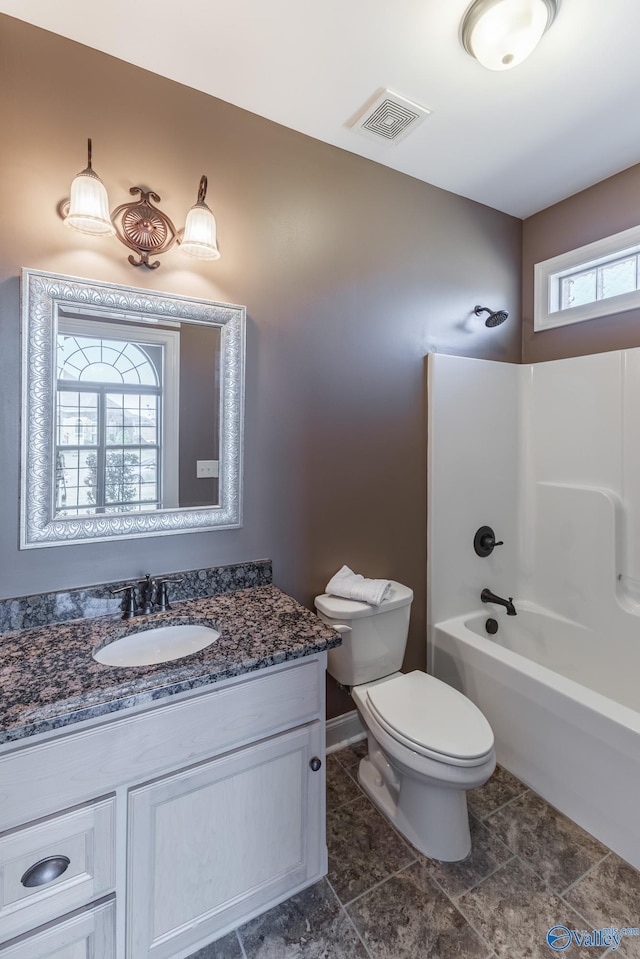 full bathroom with vanity, toilet, and washtub / shower combination