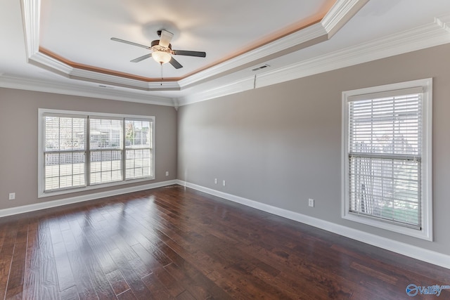 spare room with ceiling fan, a raised ceiling, ornamental molding, and dark hardwood / wood-style floors