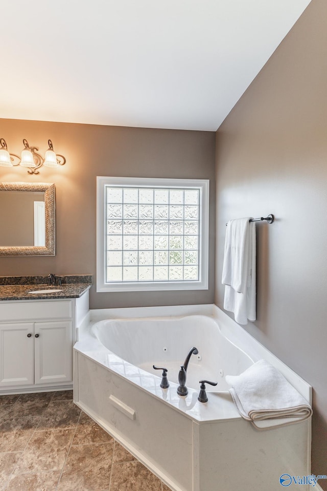 bathroom featuring vanity, a bathtub, and tile patterned floors