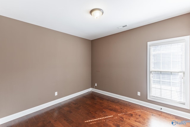 spare room featuring dark hardwood / wood-style flooring