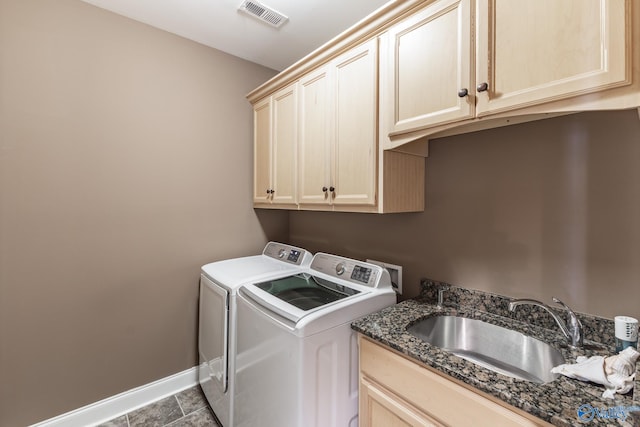 laundry room with cabinets, sink, and washer and clothes dryer