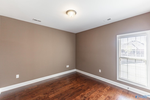 unfurnished room featuring dark hardwood / wood-style flooring