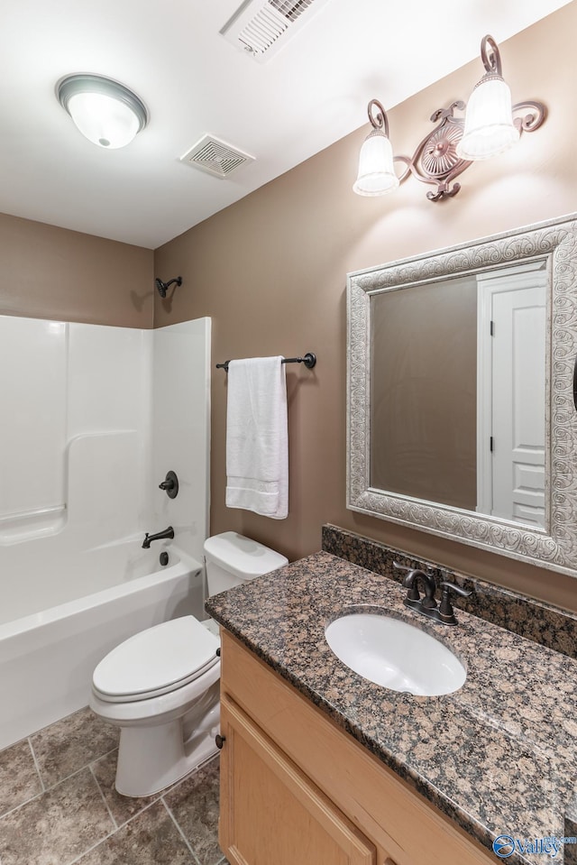 full bathroom featuring vanity, bathing tub / shower combination, toilet, and tile patterned flooring