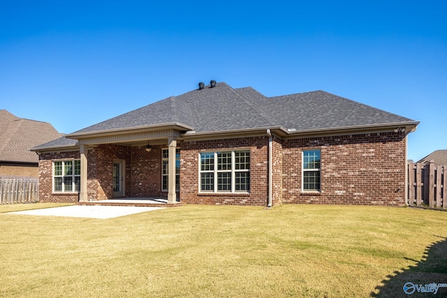 back of house featuring a patio area and a yard