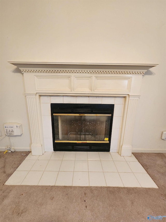 interior details with a tile fireplace and carpet floors