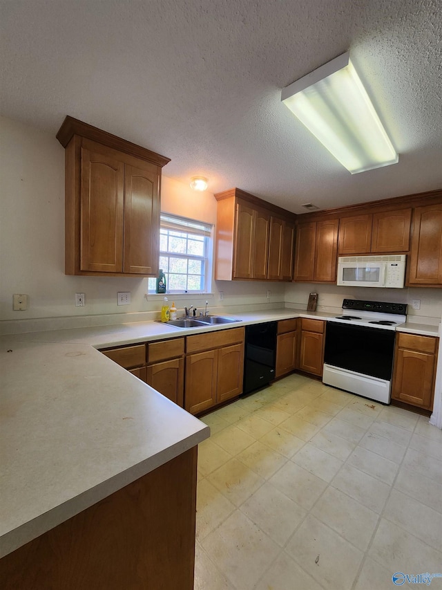 kitchen with a textured ceiling, white appliances, and sink