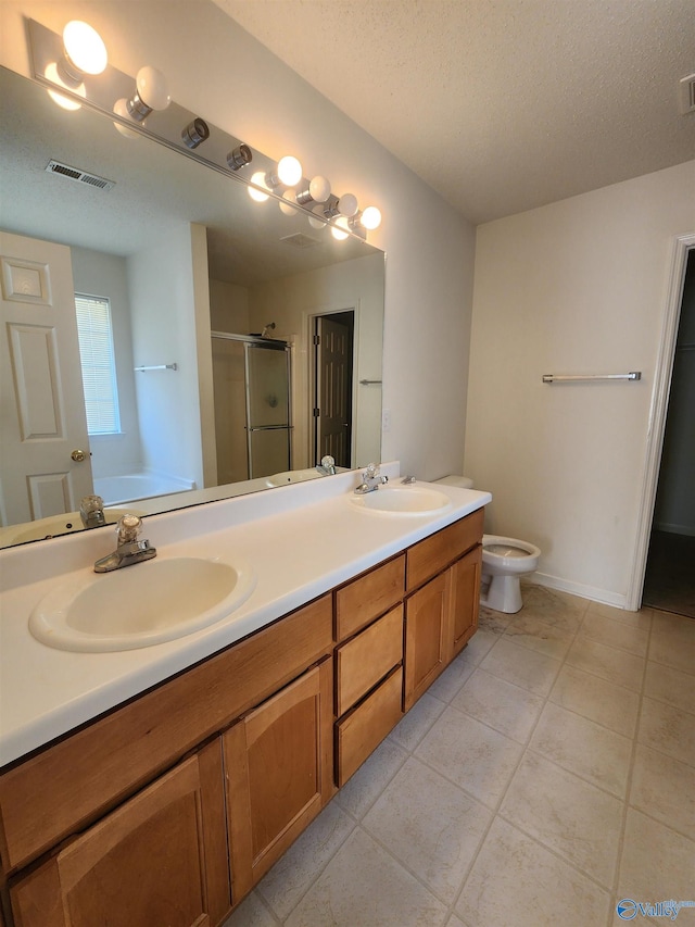 full bathroom with separate shower and tub, tile patterned floors, a textured ceiling, toilet, and vanity