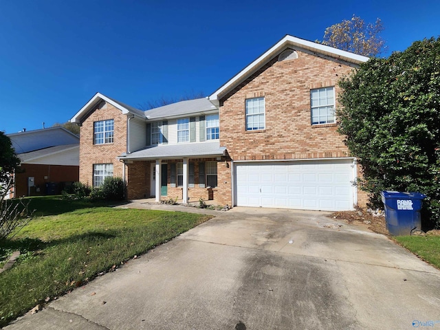 view of front property featuring a front yard, a garage, and covered porch