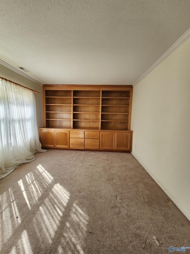 unfurnished living room featuring crown molding, light colored carpet, and a textured ceiling