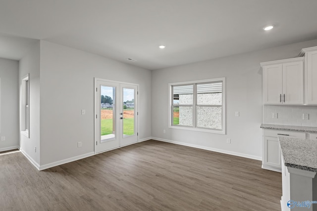 unfurnished dining area with hardwood / wood-style floors