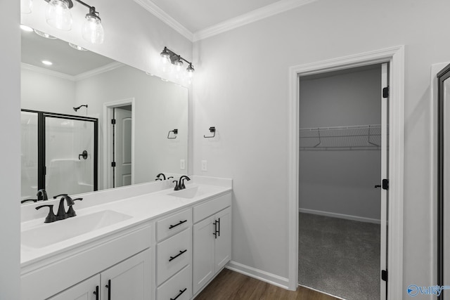 bathroom featuring vanity, crown molding, a shower with shower door, and wood-type flooring