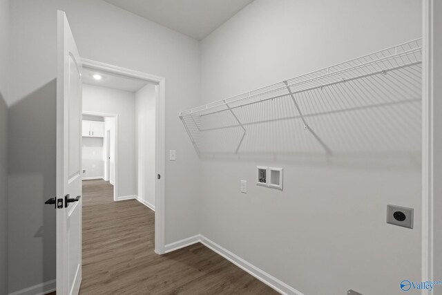 clothes washing area featuring hookup for an electric dryer, dark hardwood / wood-style flooring, and washer hookup