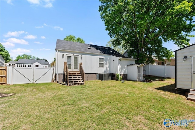 rear view of property featuring central AC, french doors, a fenced backyard, and a lawn
