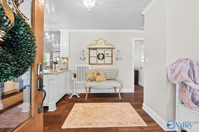 entrance foyer with visible vents, baseboards, ornamental molding, and dark wood finished floors