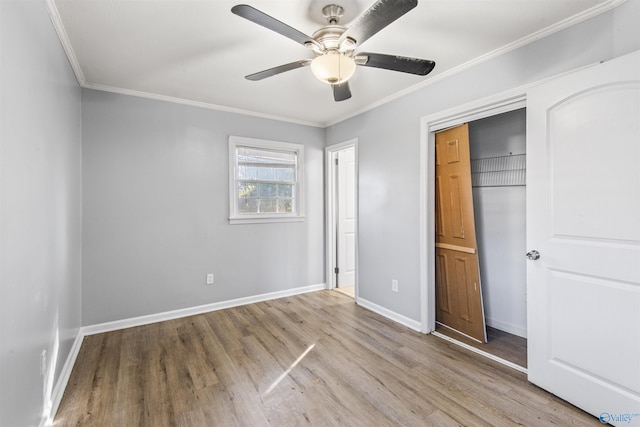 unfurnished bedroom with ceiling fan, light hardwood / wood-style floors, ornamental molding, and a closet