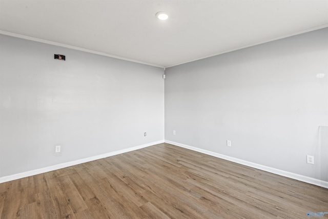 unfurnished room with light wood-type flooring and crown molding