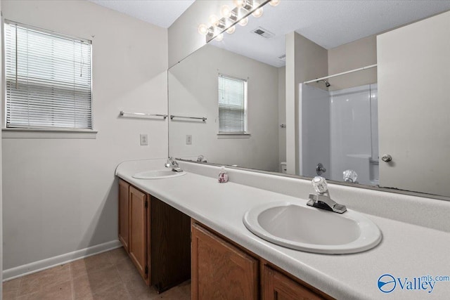 bathroom featuring vanity and a shower