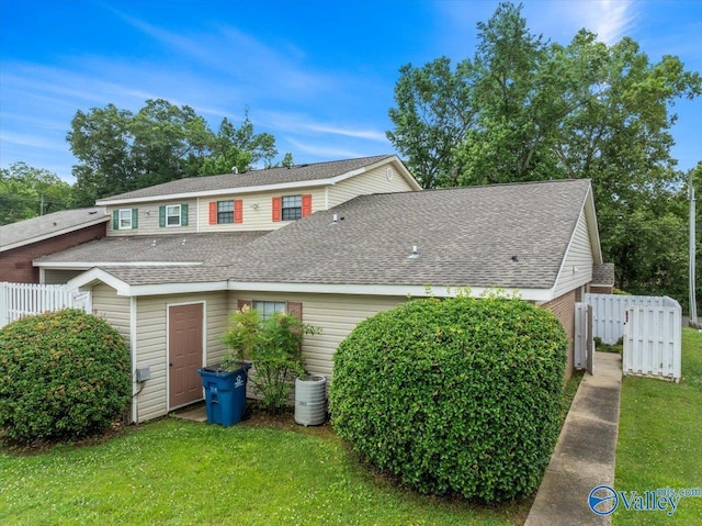 view of home's exterior with cooling unit and a lawn