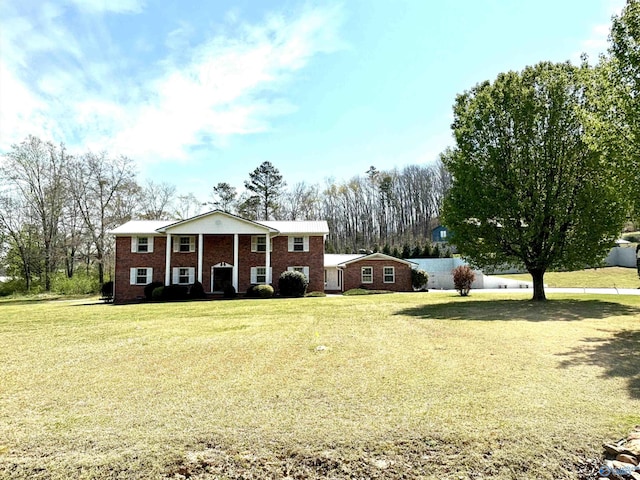 view of front of house with a front yard and brick siding