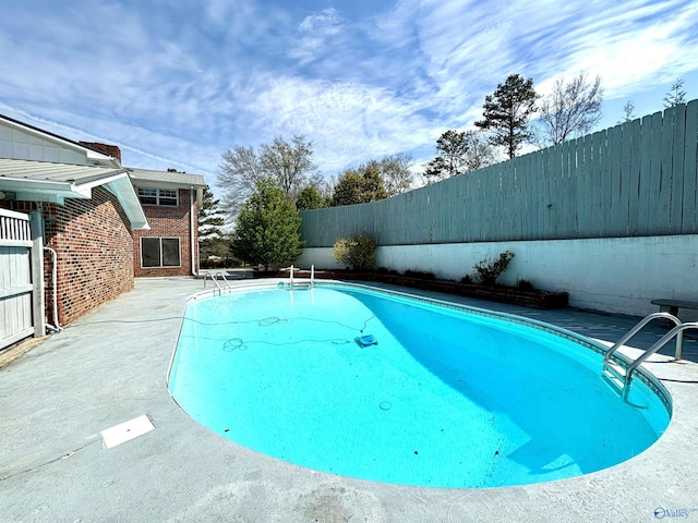 view of pool featuring a fenced backyard, a patio, and a fenced in pool